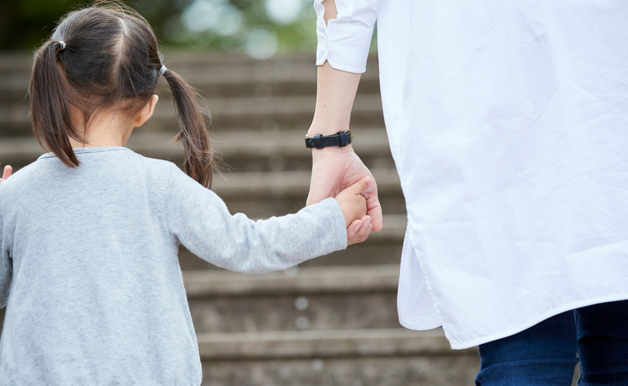 child holding her fathers hand